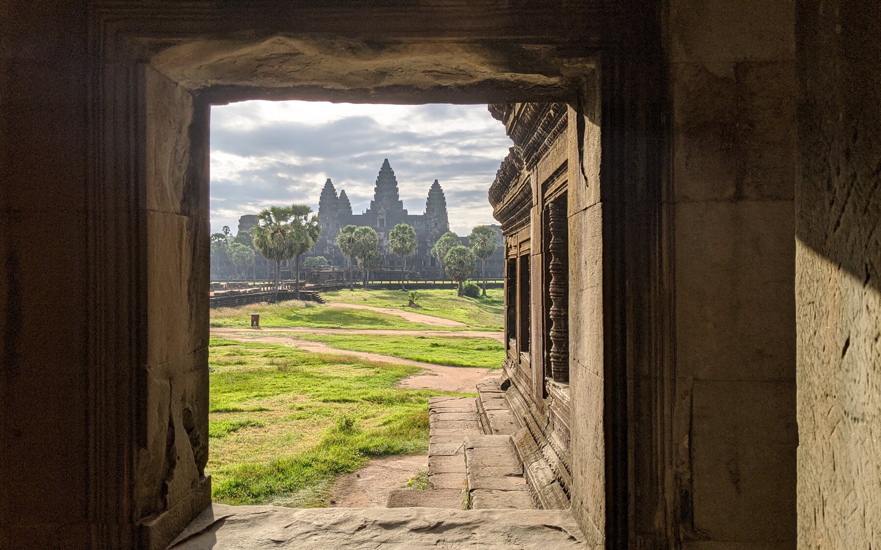 Angkor Wat seen through a shaded temple doorway